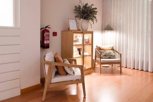 a room with a chair and a shelf with pillows at Hotel Beratxa in Tafalla