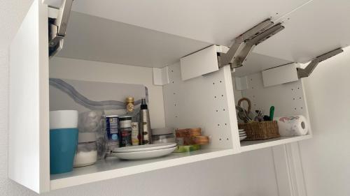 a white cabinet with some kitchen items on it at Casa Vacanza La Molaretta di San Teodoro in San Teodoro