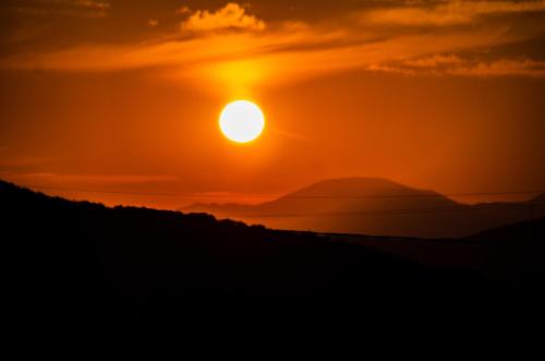a sunset with the sun setting in the background at Agriturismo Podere Luchiano in Amelia