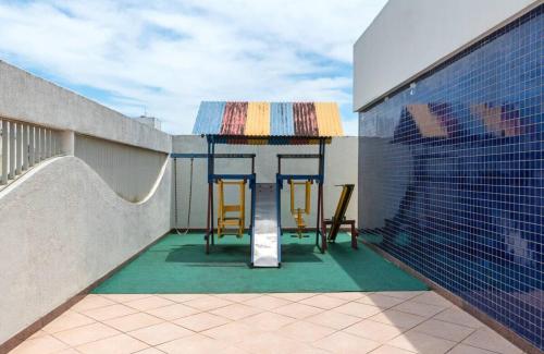 two chairs and a table on a balcony at Flatguarapari in Guarapari