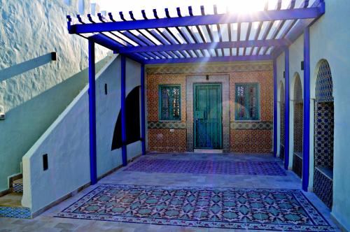 an entrance to a house with a blue door at Dar Shams Riad Medina de Sousse in Sousse