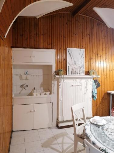 a kitchen with a sink and a table with a chair at La Cà De Zan in Mezzegra