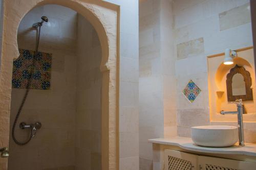 a bathroom with a sink and a shower at Dar Shams Riad Medina de Sousse in Sousse