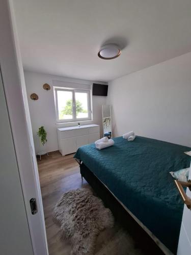 a bedroom with a green bed and a window at House of Freedom in Kruševo