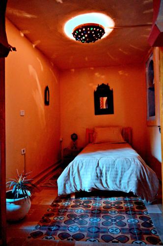 a bedroom with a bed in a room at Dar Shams Riad Medina de Sousse in Sousse