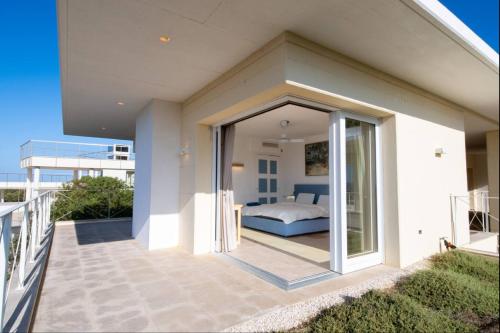 a bedroom on the balcony of a house at Villa Dea overlooking the harbor of Porto Cervo in Porto Cervo