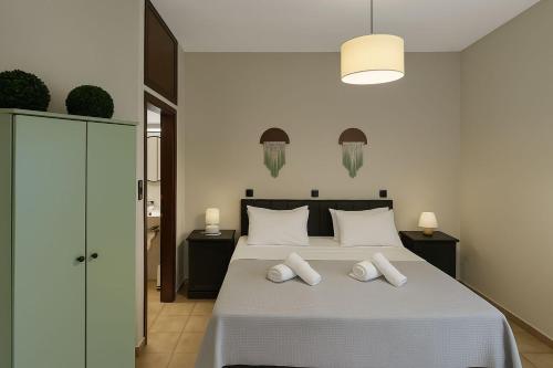 a bedroom with a bed with two white pillows at Nicolas Beach in Palaiochora