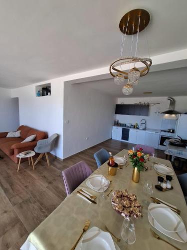 a dining room with a table and a living room at House of Freedom in Kruševo