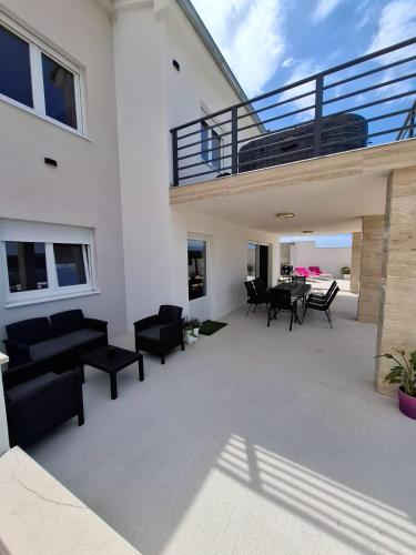 a patio with black furniture on a white house at House of Freedom in Kruševo