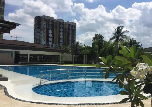 a large swimming pool in front of a building at 8C Studio Unit with Free Wifi Pool and Gym in Mandaue City