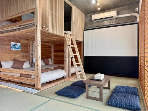 a room with two bunk beds and a blank screen at New Open Japanese style with large bath in Ukaji