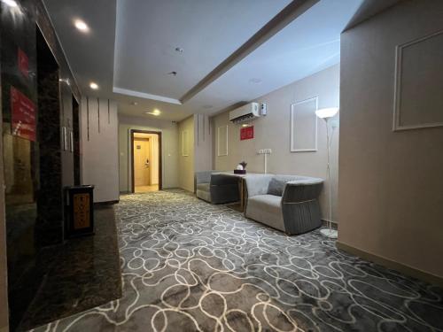 a hallway with a couch and a chair in a building at فندق نجمة روز الفندقيه Rose Star Hotel in Jeddah