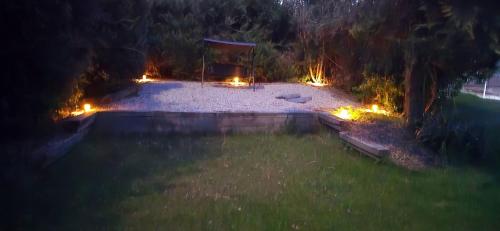 an aerial view of a backyard at night with lights at Accesible countryside retreat with private garden and all modern facilities in Chassenon