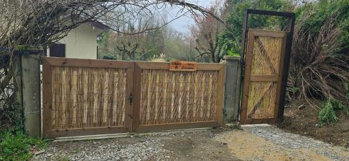 a wooden gate in front of a house at Accesible countryside retreat with private garden and all modern facilities in Chassenon