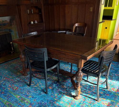 a wooden table with four chairs around it at The Converse Castle in Norwich