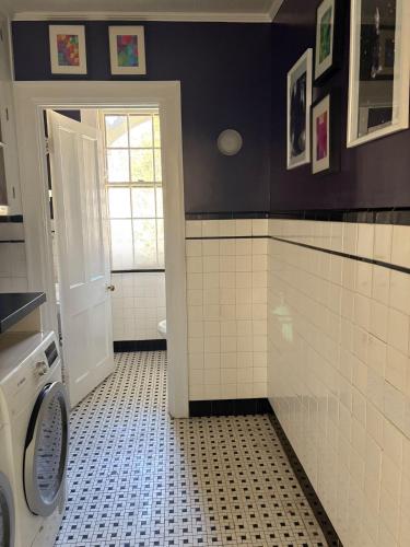 a bathroom with a black and white tiled floor at The Converse Castle in Norwich