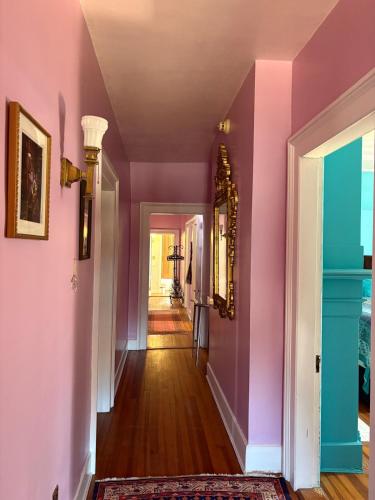 a hallway with pink and purple walls at The Converse Castle in Norwich