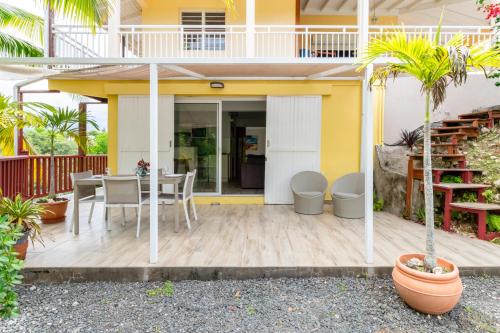 a patio with a table and chairs in a house at Jolibois Lodge & Spa in Le Gosier