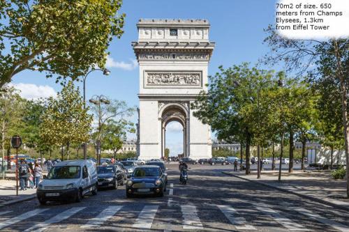 un grand monument avec des voitures garées devant lui dans l'établissement Room in apartment with view of the Eiffel Tower, à Paris