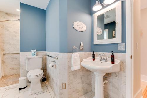 a bathroom with a white toilet and a sink at The Guest House in Excelsior
