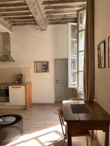 un salon avec une table et une cuisine dans l'établissement La Picholine, à Uzès