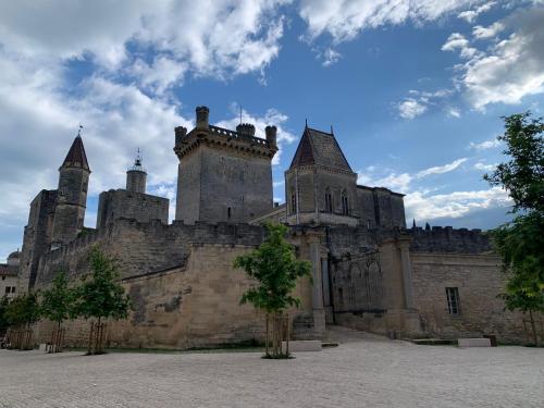an old castle with turrets on a cloudy sky at La Picholine in Uzès