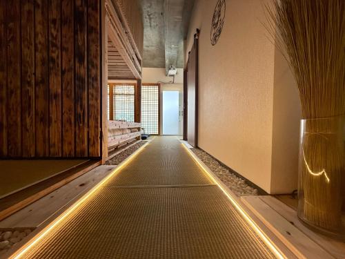 a hallway with a lighted floor in a room at New Open Japanese style with large bath in Ukaji
