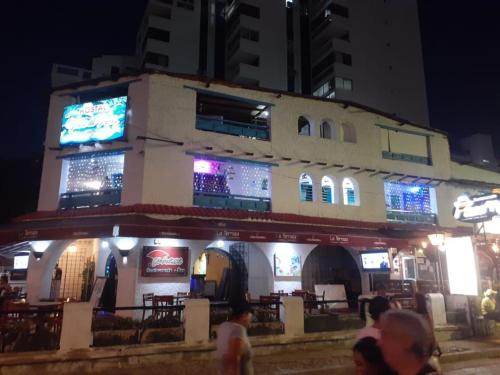 un edificio con señales a un lado por la noche en Hotel vista mar, en Santa Marta