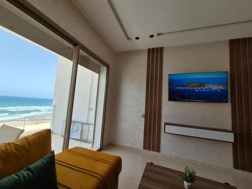 a living room with a couch and a view of the ocean at Seaside Escape - Modern Comfort and Relaxation in Mehdia in Kenitra