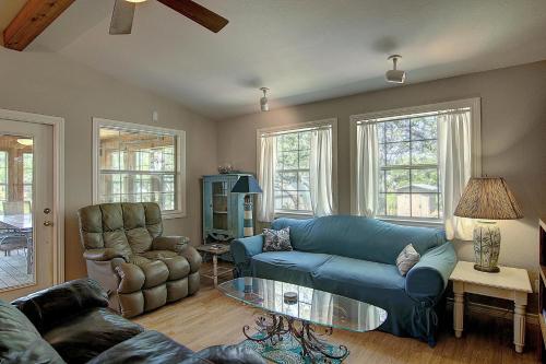 a living room with a blue couch and a chair at Fantasy Oaks Lodge in Aransas Pass