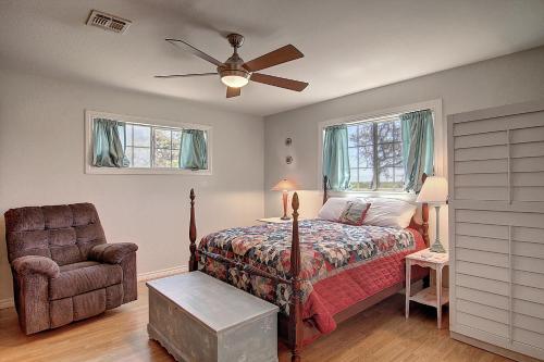 a bedroom with a bed and a chair at Fantasy Oaks Lodge in Aransas Pass