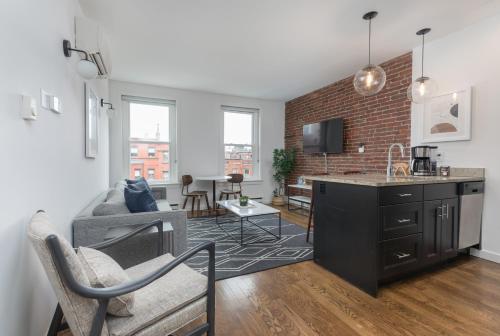 an apartment with a kitchen and a living room at 304 Newbury Street by Thatch in Boston