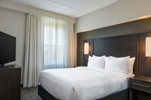 a hotel room with a large bed and a window at Residence Inn by Marriott Tallahassee Universities at the Capitol in Tallahassee