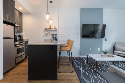 a kitchen with a sink and a counter top at 304 Newbury Street by Thatch in Boston