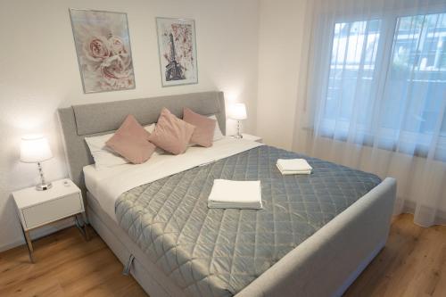 a bedroom with a large bed with two towels on it at Time4you am Bodensee mit Pool Sauna Kamin in Radolfzell am Bodensee