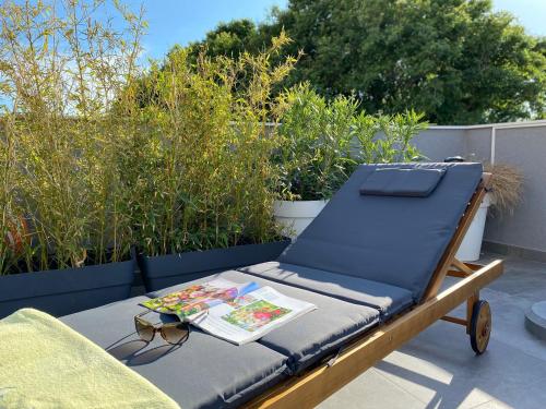 a bed on a patio with a book on it at Dalmatia Nin apartment in Nin