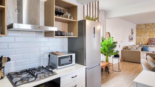 a kitchen with a stove and a refrigerator at Villa Talya in Peyia