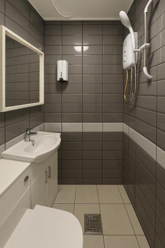 a bathroom with a toilet and a sink and a mirror at Great Georges Retreat Central Weymouth Beach Contactless Smart Accommodation in Weymouth