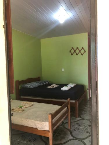 a room with two beds in a room with a mirror at Curupira Amazon Lodge - Private Jungle Tour, River Tour or Great Adventure Tour Included in the Walking Safari Price in Iranduba