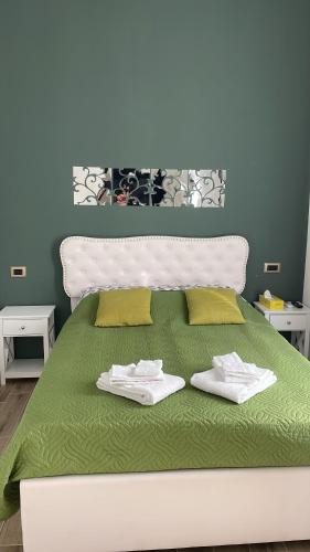 a bedroom with a bed with two towels on it at Casa Rebocco in La Spezia