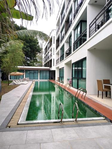 a swimming pool in front of a building at Studio at Kris Condo walk to Bangtao beach 2304 in Bang Tao Beach
