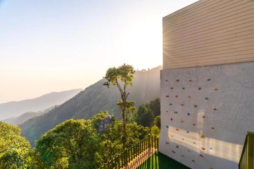 a wall with a climbing wall on the side of a building at The English Country House in Mussoorie