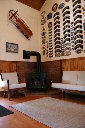 a living room with a fireplace and a stove at Gray Ghost Inn in West Dover