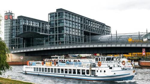 a boat in the water under a bridge at Garner Hotel Berlin - Charlottenburg, an IHG Hotel in Berlin