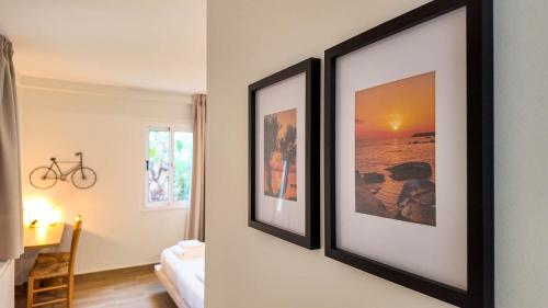 two framed pictures hanging on a wall in a room at Villa Talya in Peyia