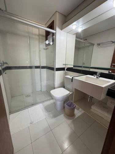 a bathroom with a sink and a toilet and a shower at Kariri Beach Residence in Caucaia