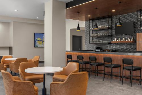 a bar in a restaurant with chairs and tables at Hyatt House Mississauga / Airport Corp Center in Mississauga