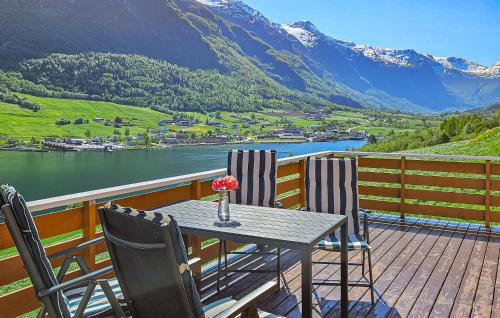 a table and chairs on a deck with a view of a mountain at Amazing Home In Olden With Wifi in Olden