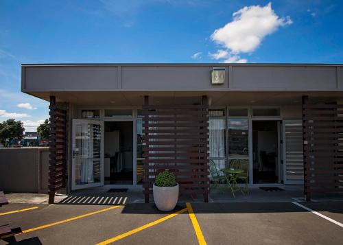a building with a planter in a parking lot at Aspree Motor Inn in Palmerston North