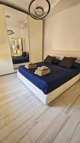 a bedroom with a large bed with towels on it at Appartamento Lindo e Dora - A due passi dal mare in San Benedetto del Tronto